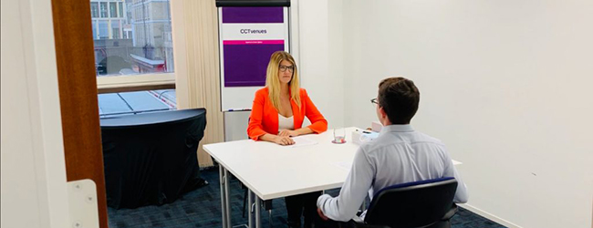 woman teaching man in room