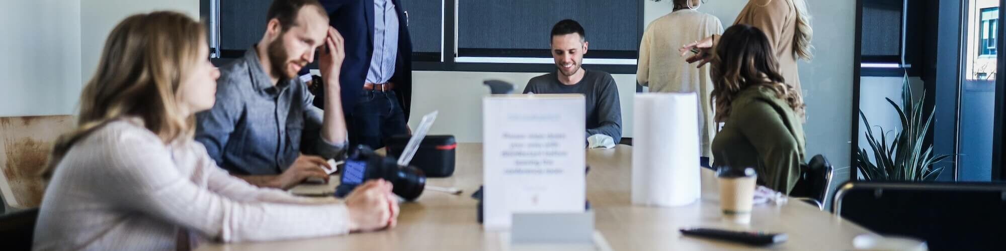 people gathered round a meeting table