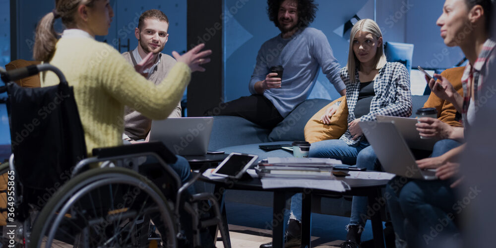 A diverse group of people having a meeting in an office.