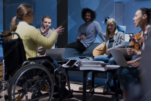 A diverse group of people having a meeting in an office.