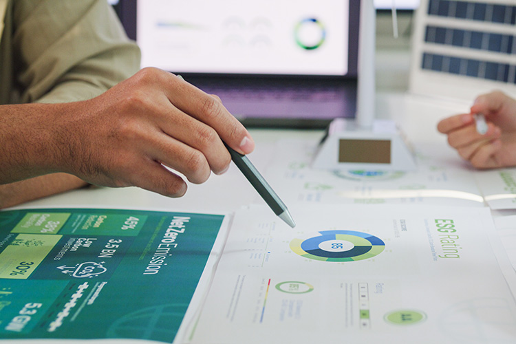 People with pens planning environment friendly strategies.