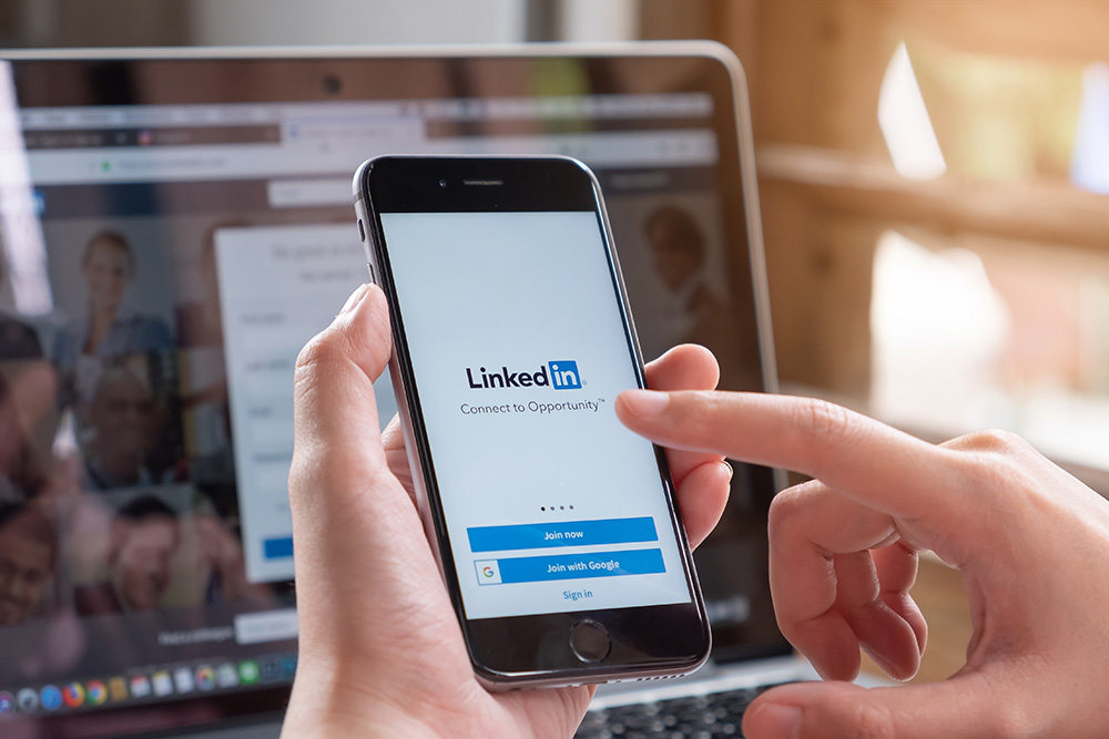 LinkedIn open in phone and laptop.