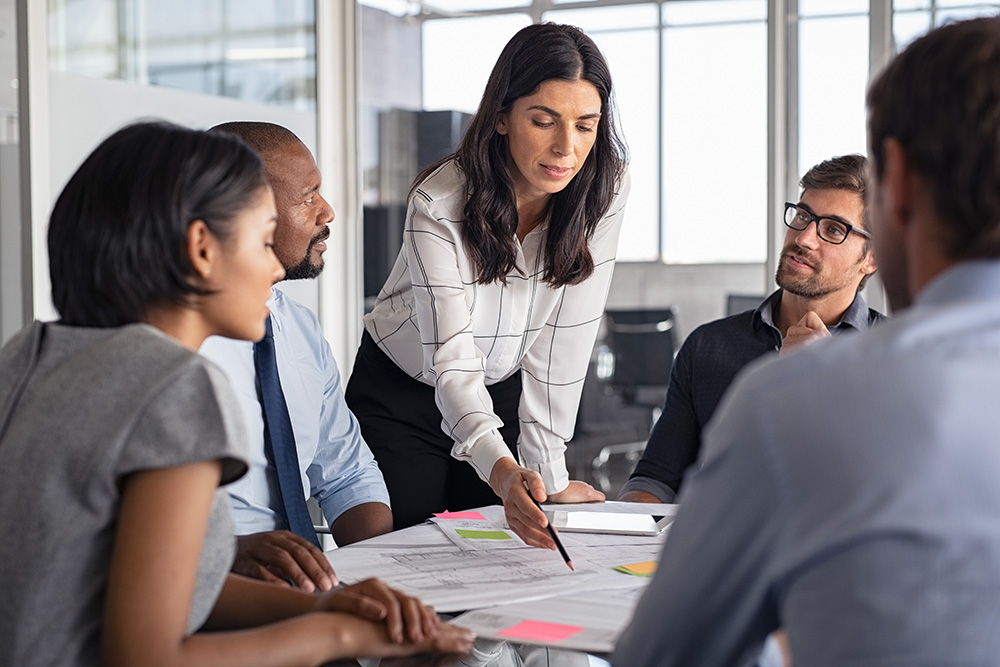 People in office discussing a plan.
