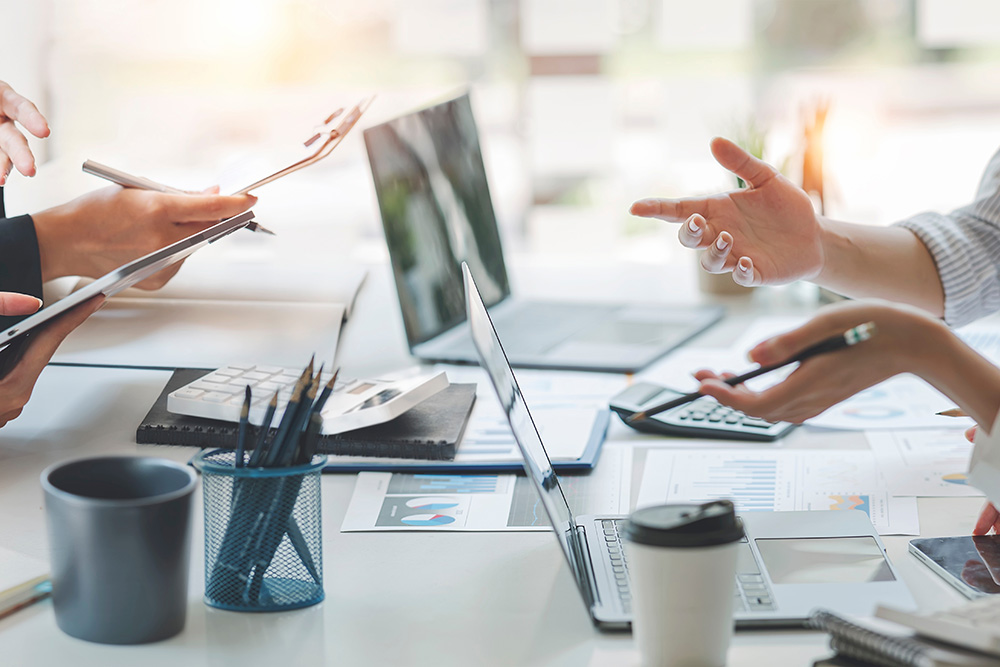 hands raised on busy desk as if in discussion